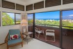 The private lanai off of the master bedroom features seating for two
